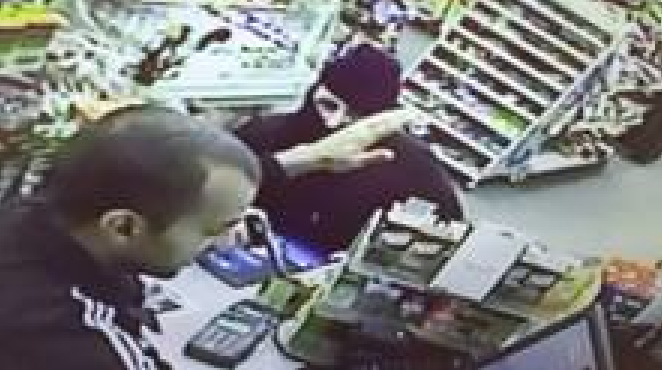 Store surveillance image of man wanted in armed robbery.