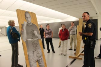 Officer Mark Ampuja, right, with members of the Citizens Police Academy in the department's firing range.