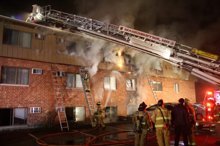 Manchester firefighters battle the Dec. 21 blaze at 65 Log Street.