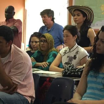 Students listen to one another talk about how the program has improved their ability to communicate, find work and be part of the community.