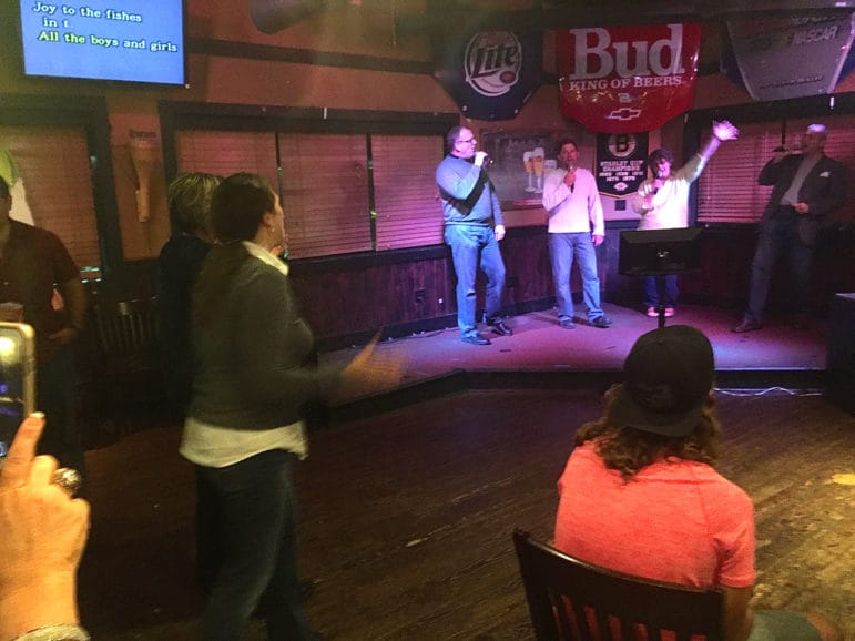Lots of support from the crowd for a "Joy to the World" quartet during Candidate Karaoke night.