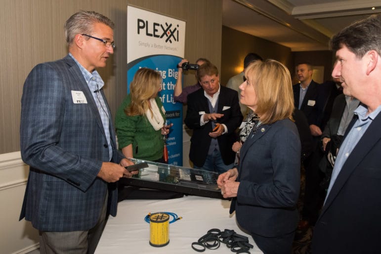 Michael Welts, VP of Marketing for Plexxi, describes his product, The Plexxi Switch 2, to New Hampshire Governor Maggie Hassan as part of the Product of the Year Award product demonstration portion of the event.