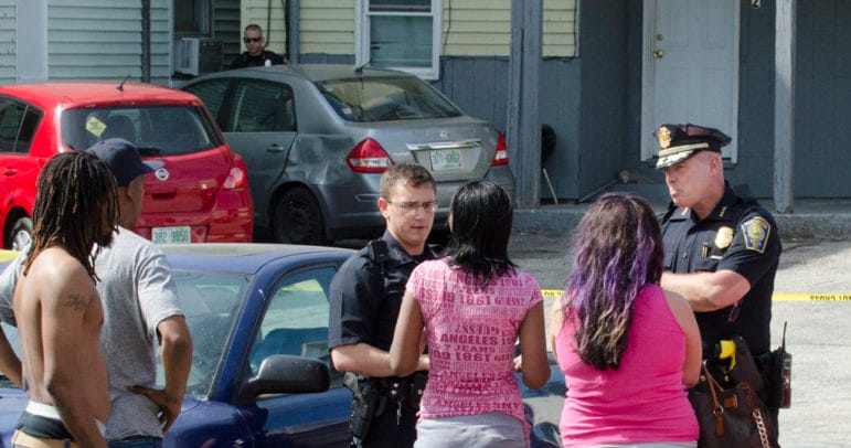 Chief Nick Willard, right, speaks with witnesses at the scene of a fatal shooting June 1.