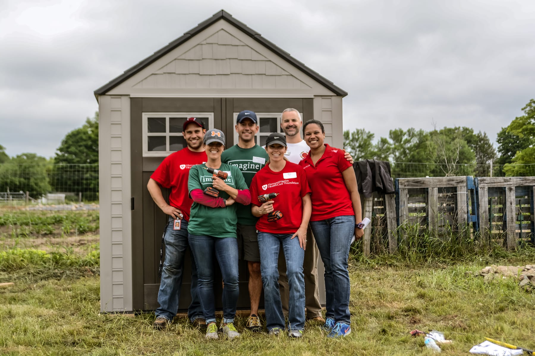 More than 100 volunteers from Harvard Pilgrim Health Care, Dartmouth Hitchcock, and Eastern Bank participated in a Day of Service building a garden shed and weeding and gardening in the NH Food Bank’s Production Garden on North River Road in Manchester. 
