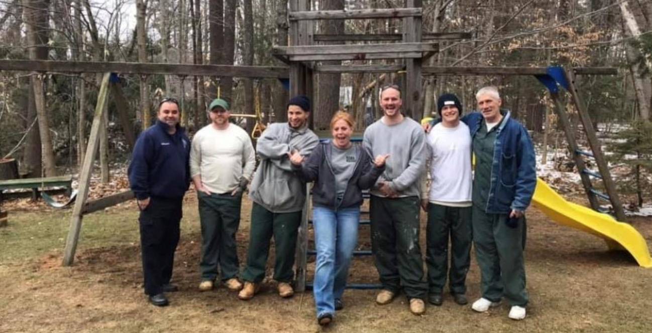 Prisoners in transition swing into action to rebuild play set for foster kids