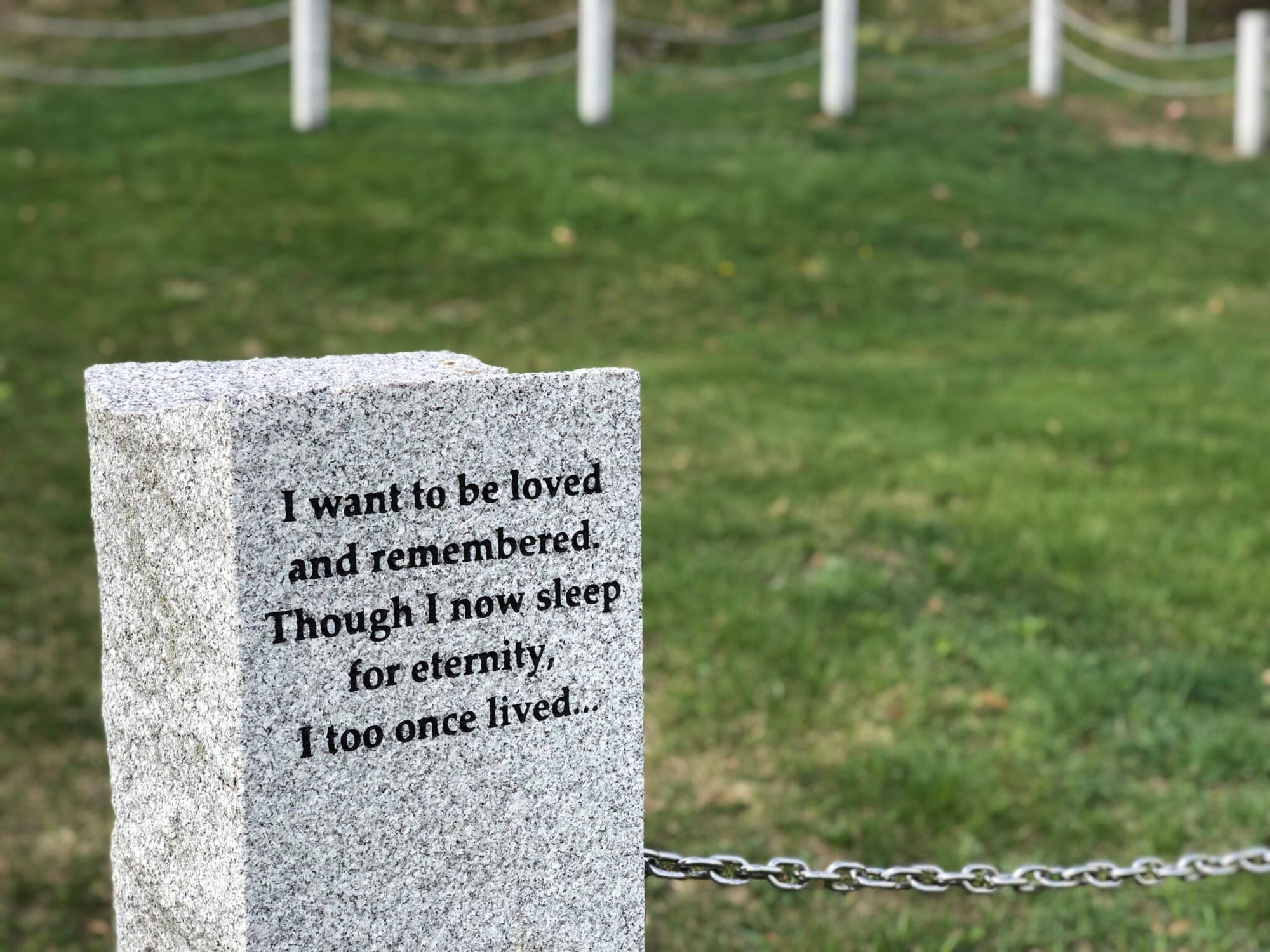 Next to an old ball field on Pleasant Street in Concord are unmarked graves of New Hampshire Hospital patients who died without anyone to claim them. (Hadley Barndollar | New Hampshire Bulletin)