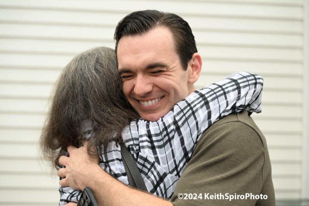 Crazy for you photo by Keith Spiro of actor Max Clayton receiving a hug.