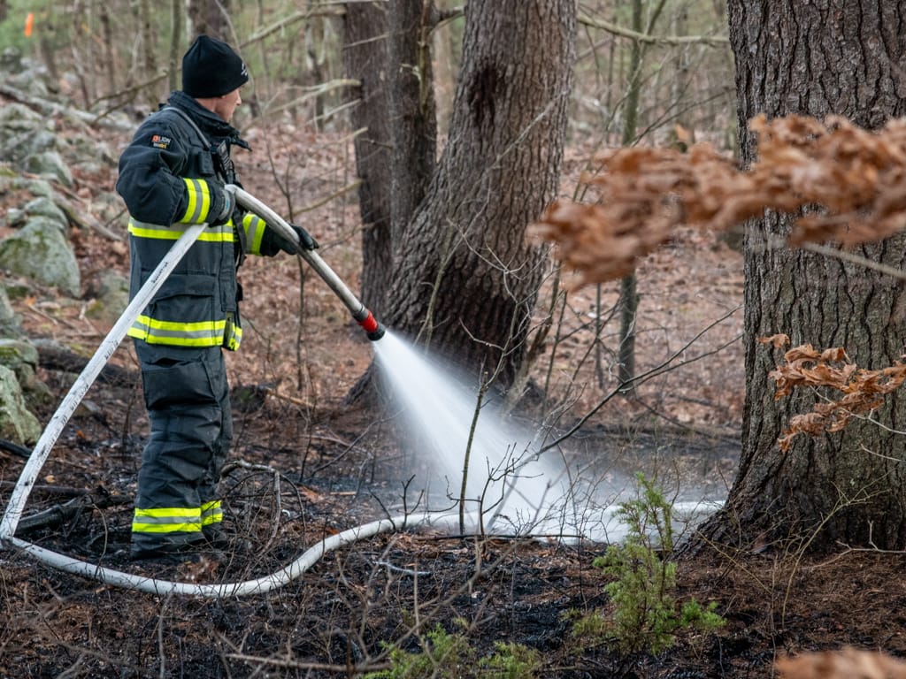 Fire pit sparks brush fire in Hooksett