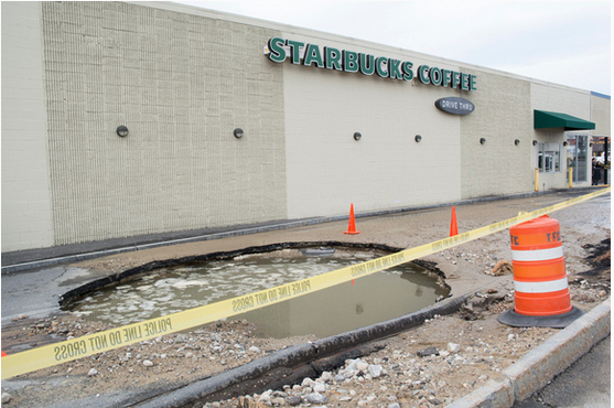 Sinkhole closes Starbucks Drive-thru, tries to swallow police cruiser post image