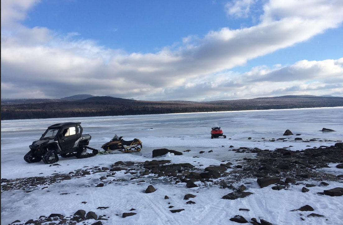 Snowmobilers stuck on lake after breaking through ice post image
