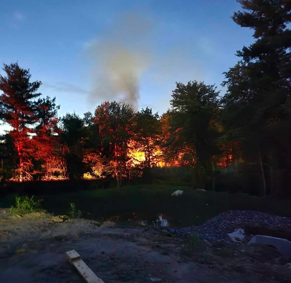Firefighters challenged by brush fire deep in woods off Sheffield Road at abandoned encampment post image
